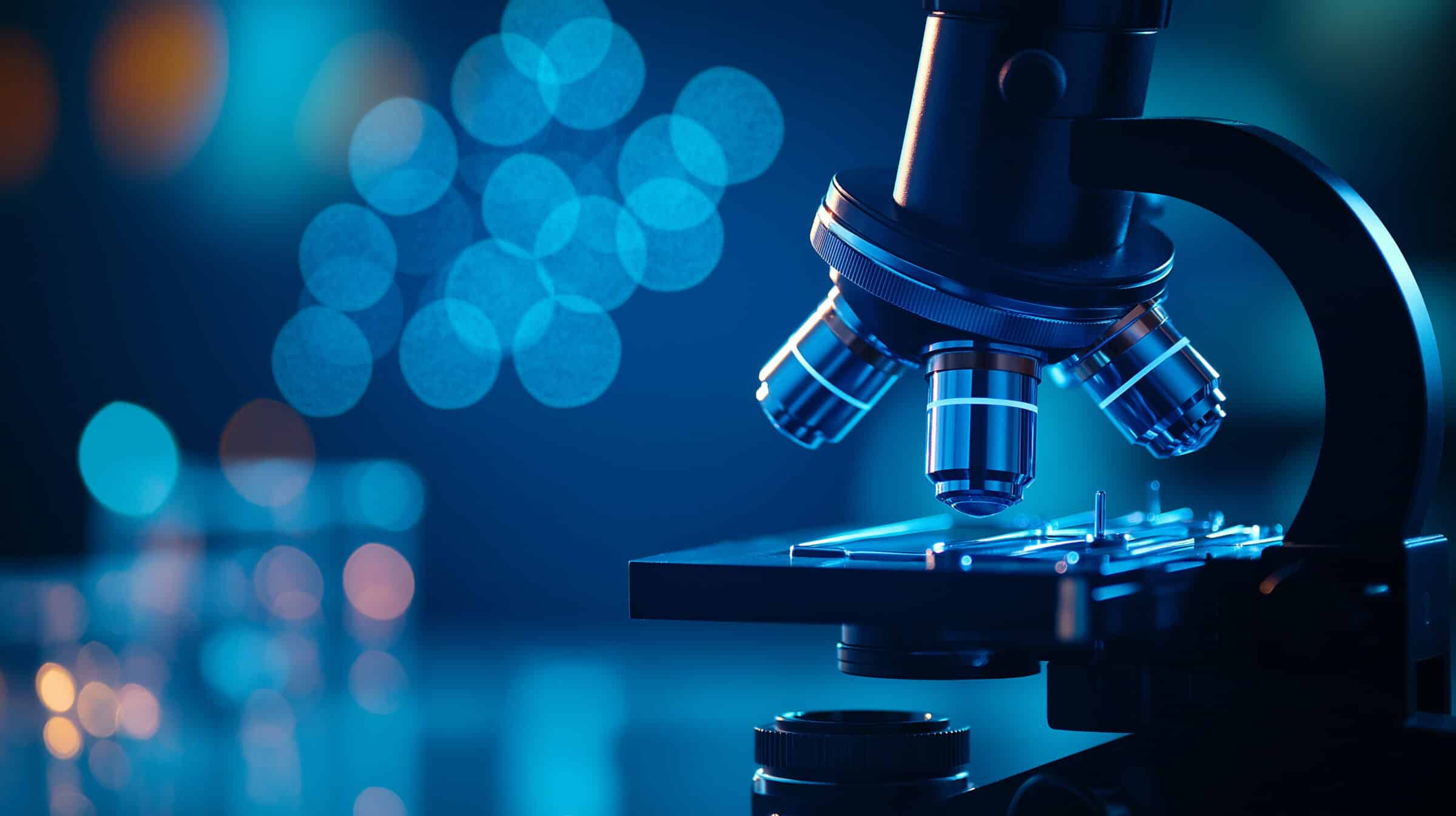 modern microscope in lab, illuminated by blue light, showcases intricate details and advanced technology, creating captivating scientific atmosphere