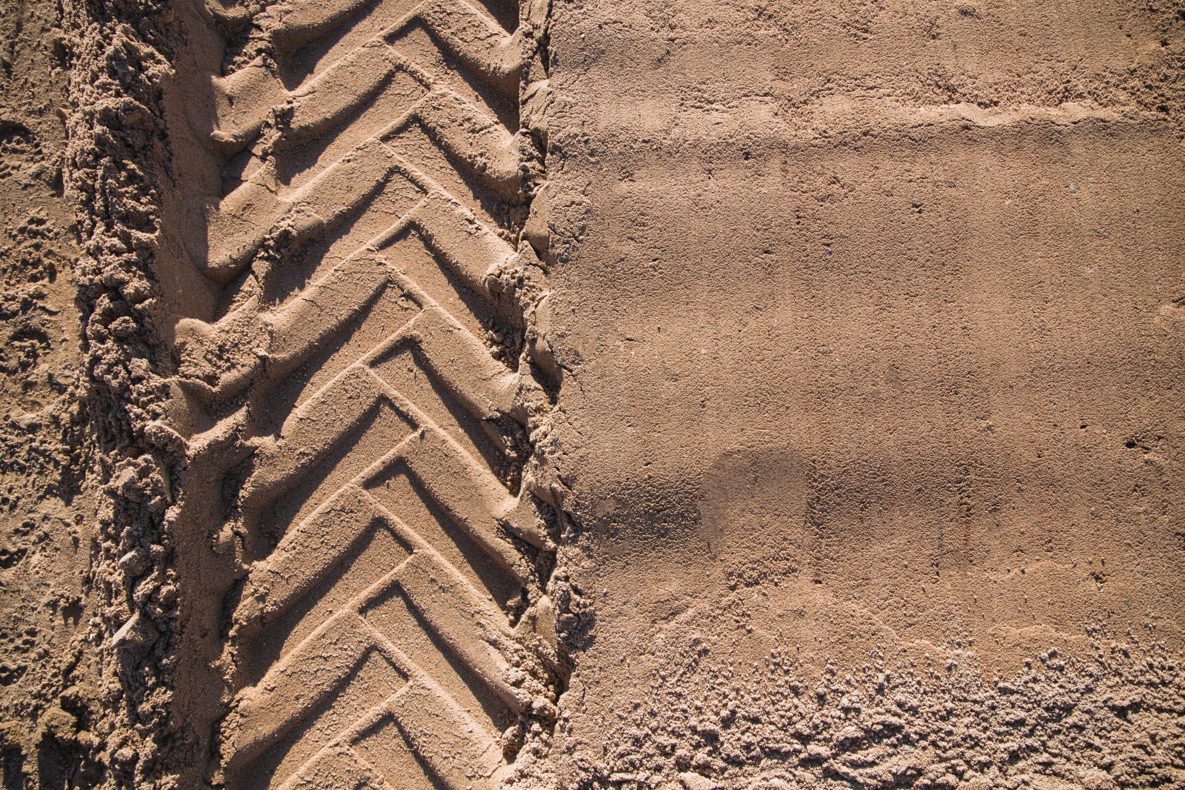 sand with tractor wheel tread on it