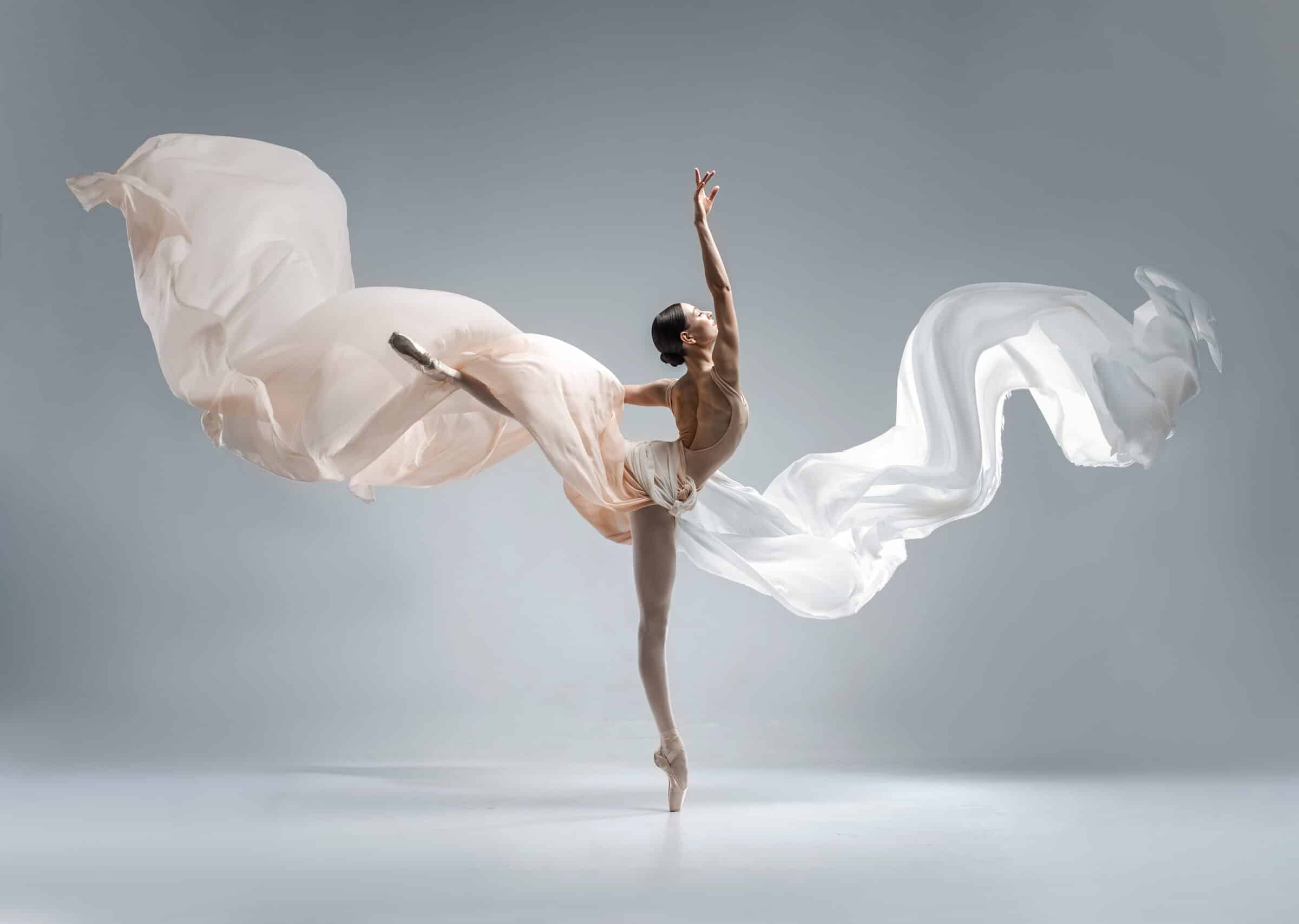 Beautiful ballerina dancing in the body color ballet leotard with body color cloth. She danced on ballet pointe shoes.