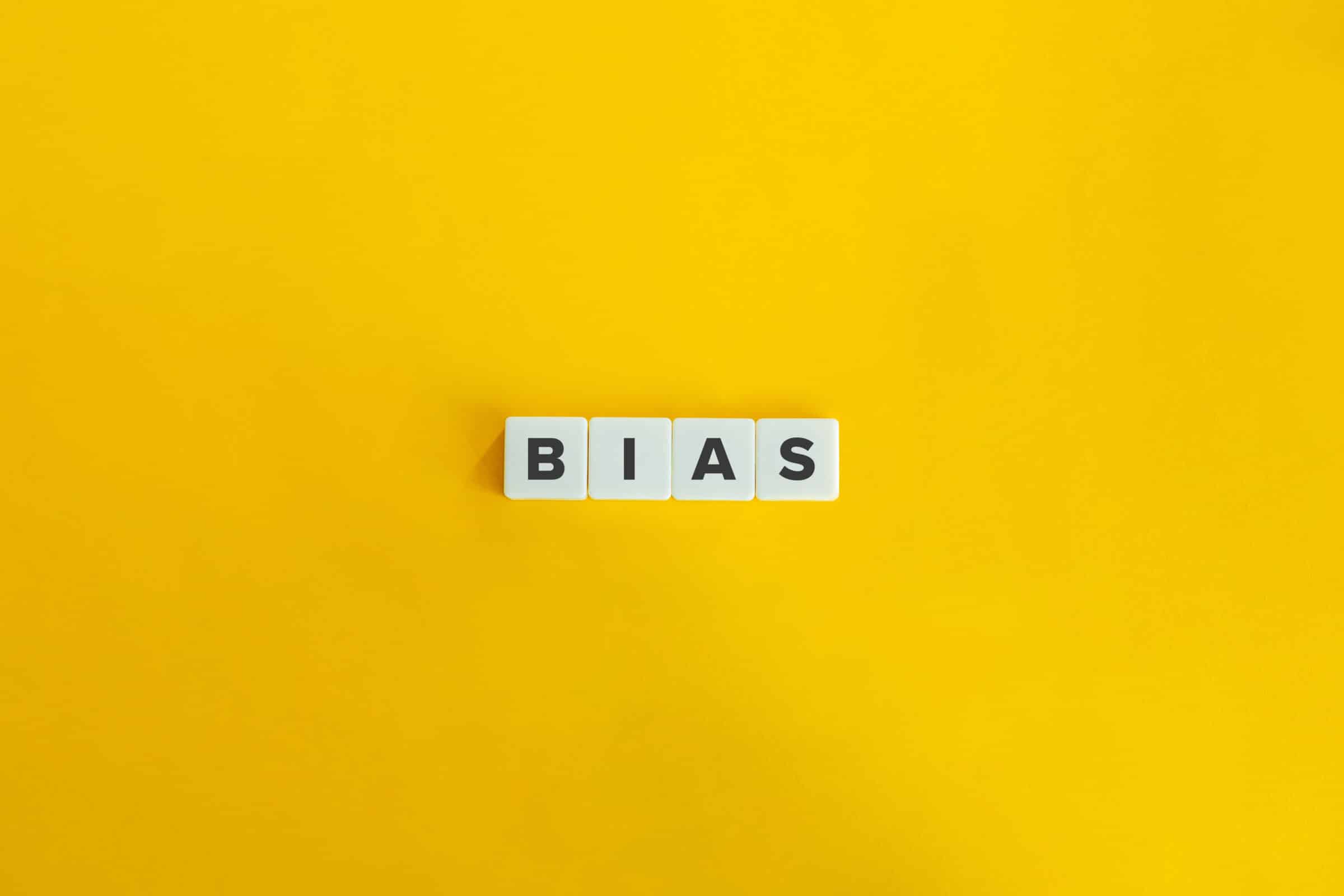 Bias Word on Letter Tiles on Yellow Background. Minimal Aesthetics.