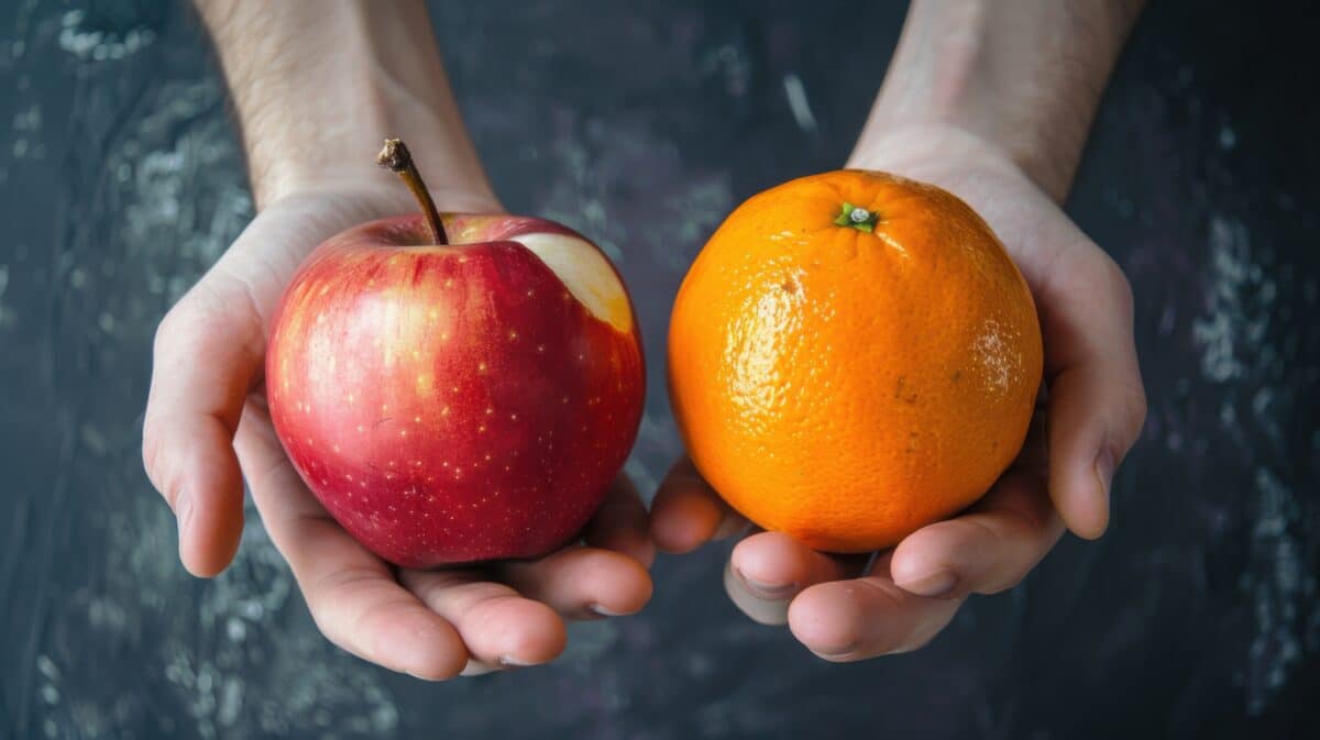 Red Apple and Orange comparison, Hands holding a red apple and an orange fruit