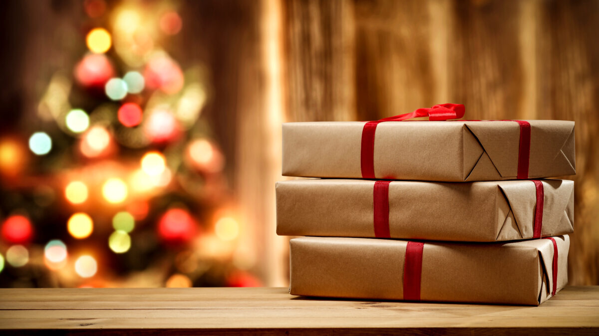 Christmas gift and wooden wall background.