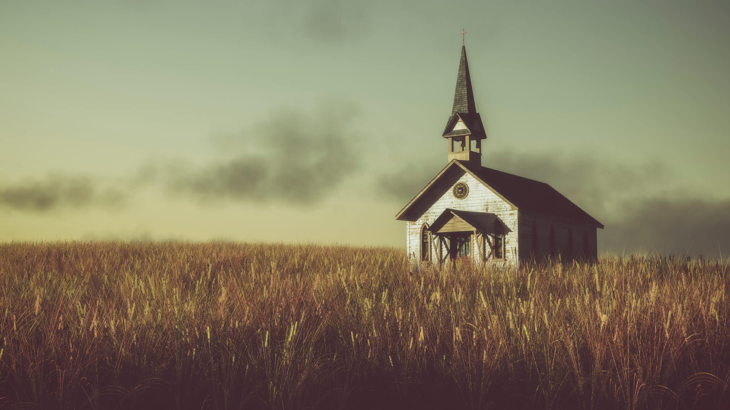 Old abandoned white wooden chapel on prairie at sunset with clou