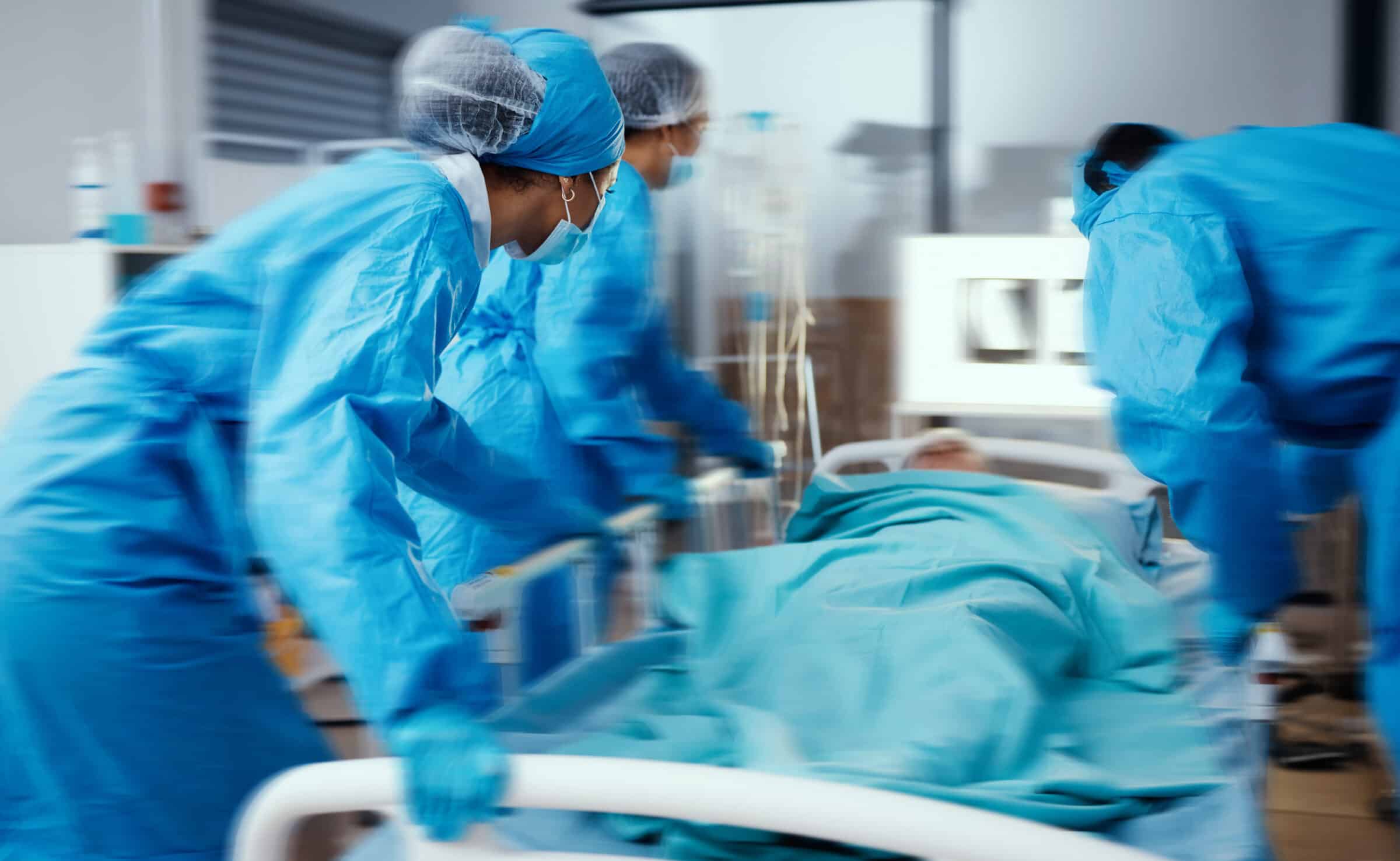 Women, man and hospital bed in motion blur of emergency surgery, healthcare wellness or risk condition operation. Doctors, nurses and medical workers with patient in busy er, theatre room or teamwork